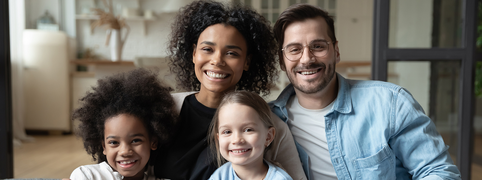 Portrait of happy multiracial family relax at home